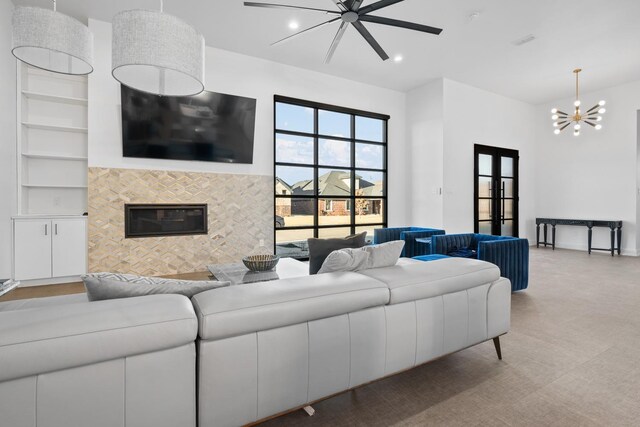 4803 120th St, Lubbock, TX 79424 - living area with a chandelier, a tiled fireplace, french doors, carpet, and recessed lighting