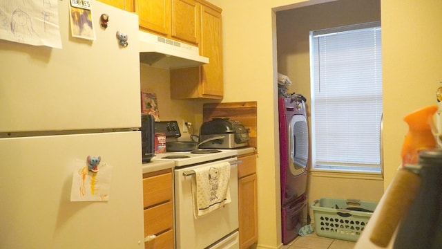 kitchen with white appliances, washer / clothes dryer, and light tile patterned floors