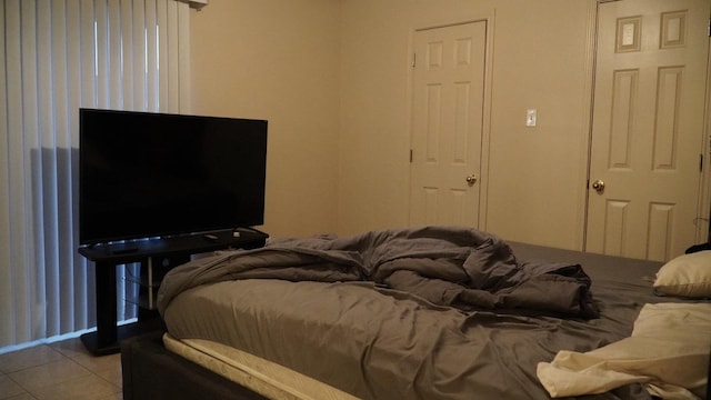 bedroom with light tile patterned floors