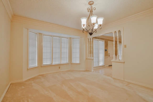 empty room featuring ornamental molding, light carpet, and a textured ceiling