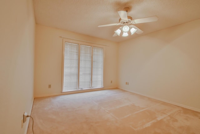 spare room featuring ceiling fan, carpet floors, and a textured ceiling