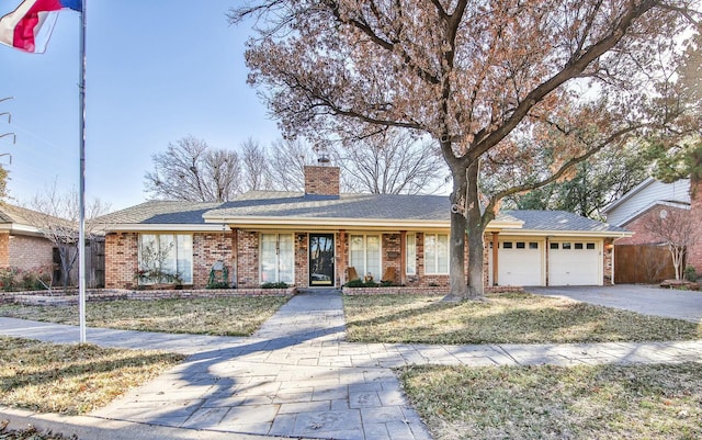 ranch-style home with a garage and a front yard