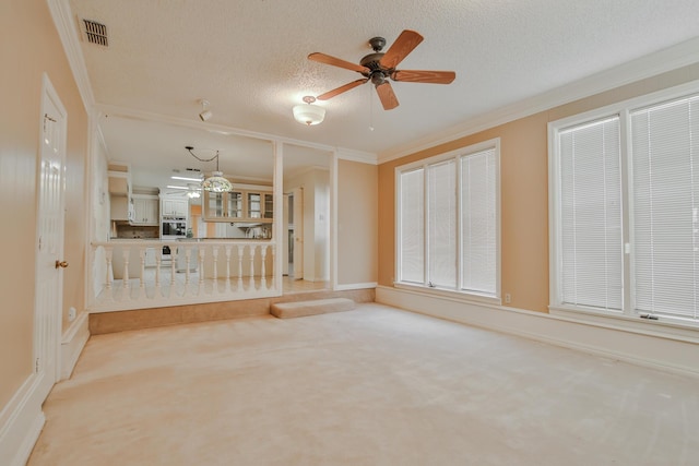 unfurnished living room with crown molding, a textured ceiling, and carpet