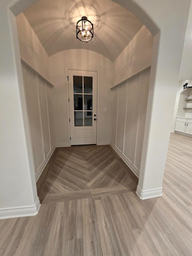 entryway with vaulted ceiling and light hardwood / wood-style floors