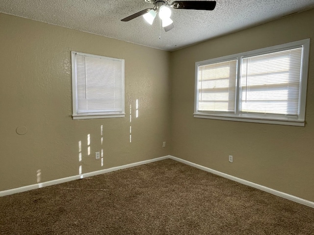 carpeted empty room with ceiling fan and a textured ceiling