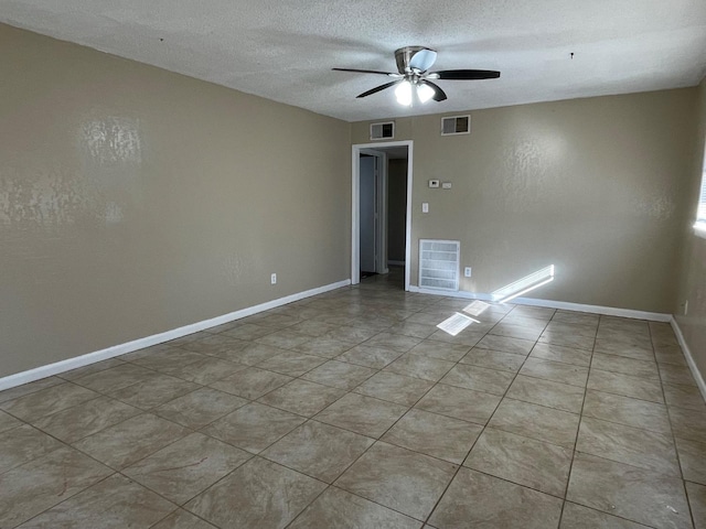 spare room featuring ceiling fan and a textured ceiling