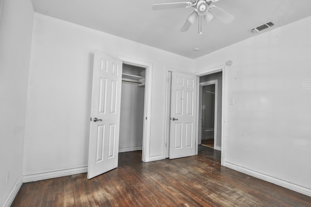 unfurnished bedroom with ceiling fan, dark hardwood / wood-style floors, and a closet