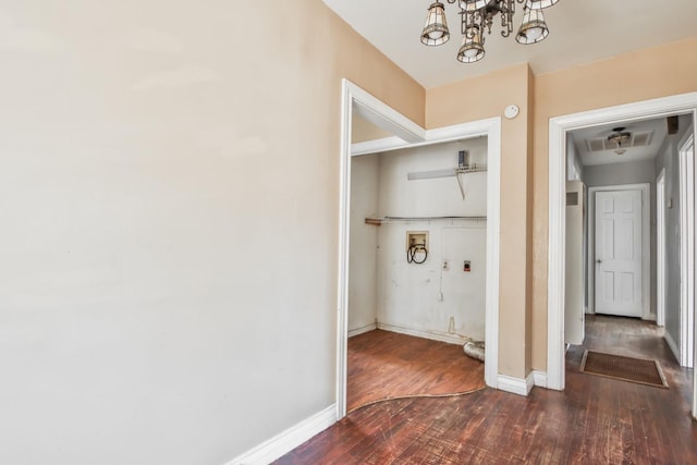 hall featuring an inviting chandelier and dark hardwood / wood-style flooring