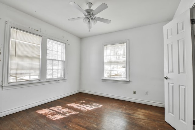 empty room featuring dark wood-type flooring and ceiling fan