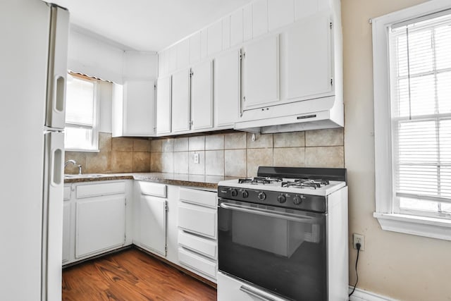 kitchen featuring white cabinets, white appliances, and decorative backsplash