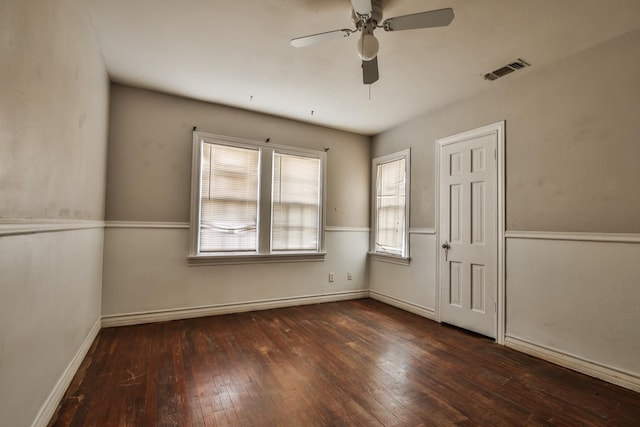 spare room featuring dark hardwood / wood-style floors and ceiling fan