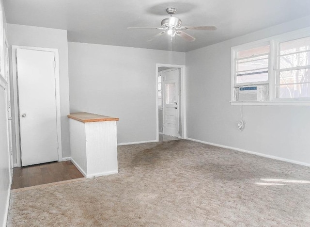 spare room featuring carpet flooring, cooling unit, and ceiling fan