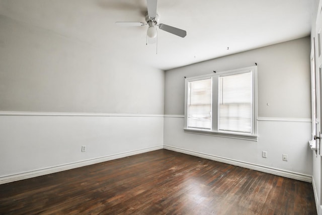 empty room featuring dark wood-type flooring and ceiling fan