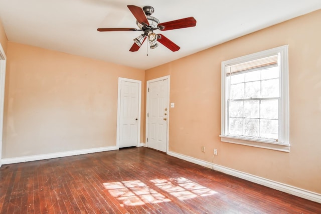 spare room featuring ceiling fan and dark hardwood / wood-style floors