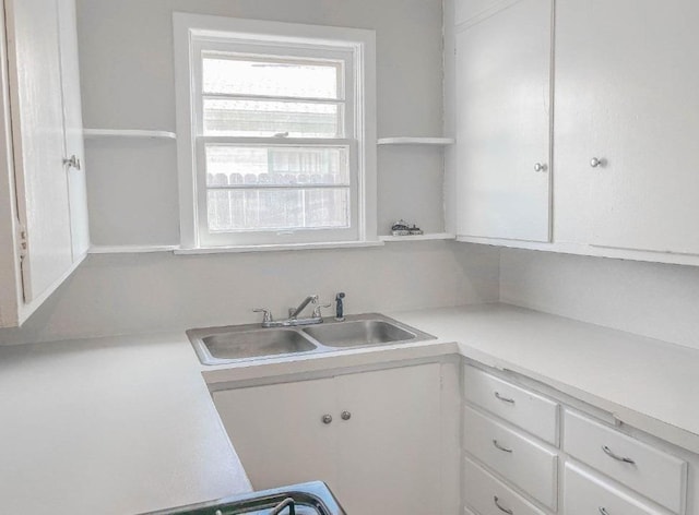 kitchen with white cabinetry and sink