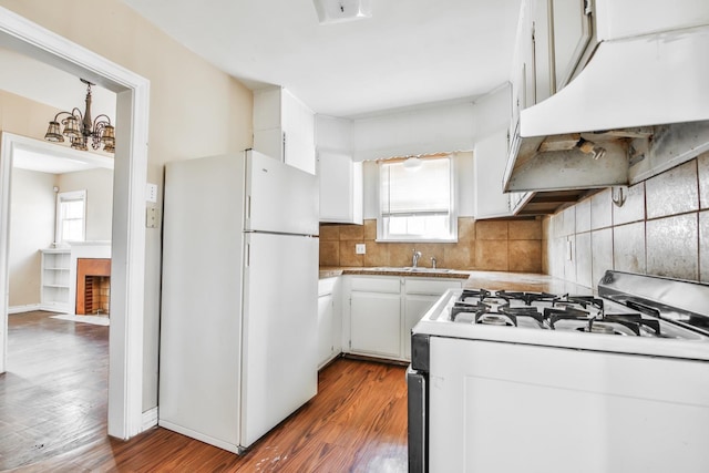 kitchen with white cabinetry, white appliances, and decorative backsplash