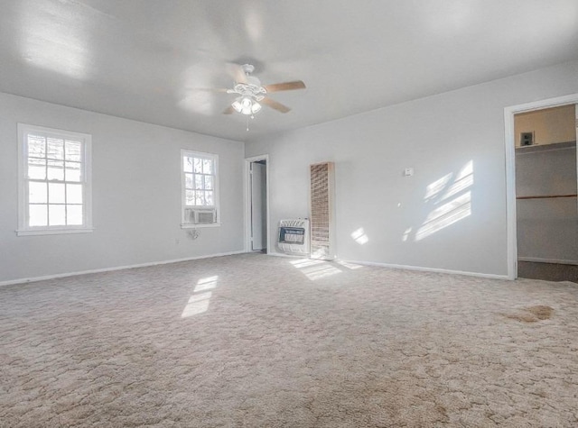 carpeted spare room featuring cooling unit, ceiling fan, and heating unit