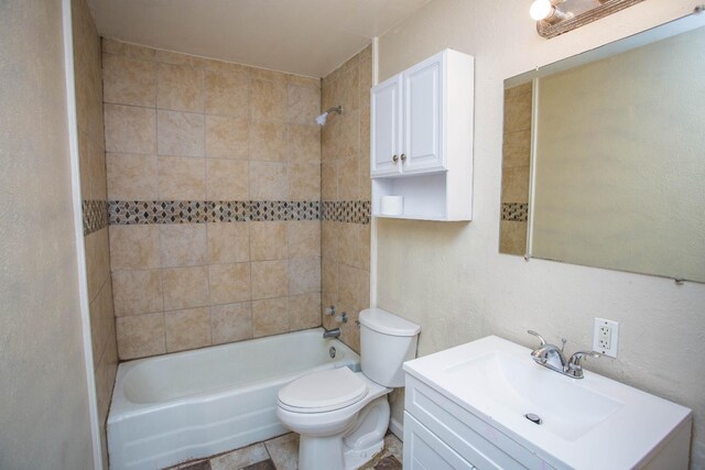 full bathroom featuring vanity, toilet, and tiled shower / bath