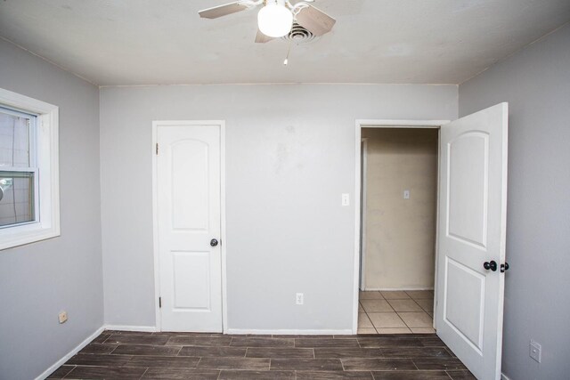 unfurnished bedroom featuring ceiling fan