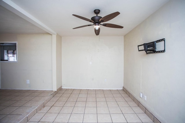 empty room featuring light tile patterned floors and ceiling fan