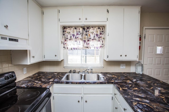 kitchen featuring black electric range, sink, white cabinets, and backsplash