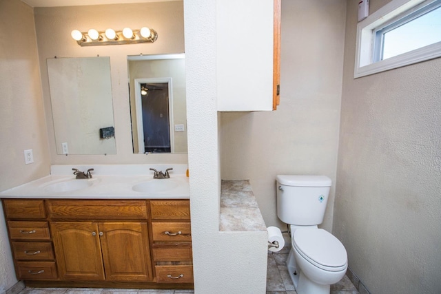 bathroom featuring tile patterned floors, vanity, and toilet