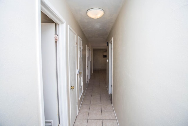 corridor featuring light tile patterned flooring