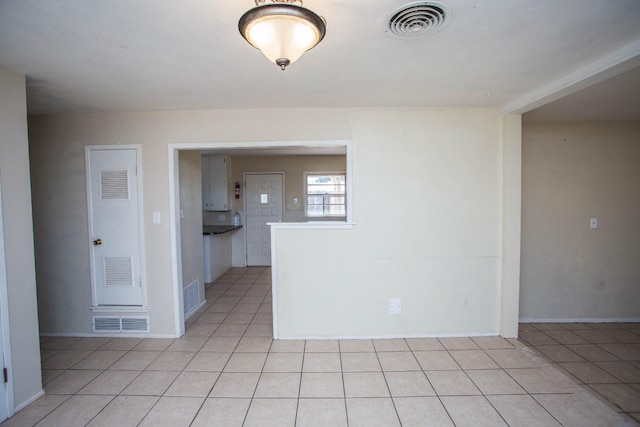 empty room with light tile patterned floors