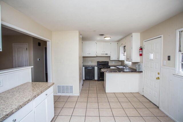 kitchen with sink, white cabinetry, black appliances, light tile patterned flooring, and decorative backsplash