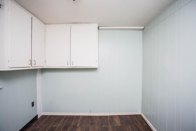 clothes washing area with dark hardwood / wood-style floors