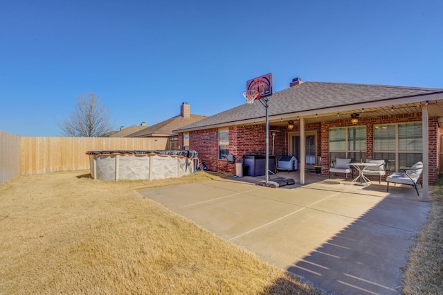 rear view of property featuring a covered pool