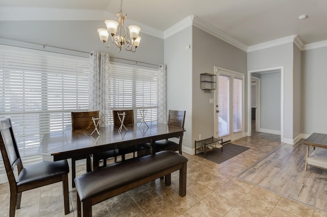 tiled dining space with lofted ceiling, crown molding, and a chandelier