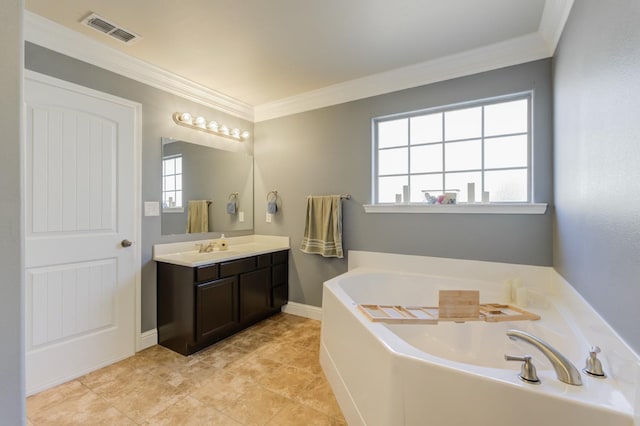 bathroom featuring vanity, crown molding, and a bathing tub