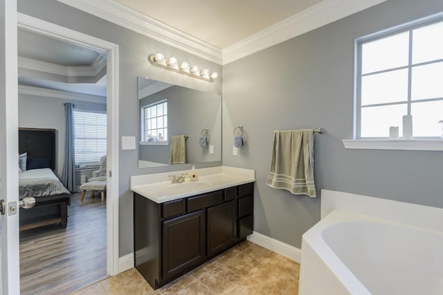 bathroom featuring tile patterned flooring, ornamental molding, a bathing tub, and vanity