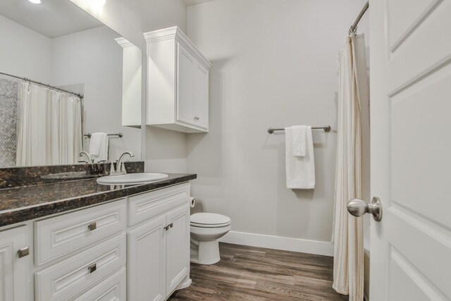 bathroom with vanity, a shower with curtain, wood-type flooring, and toilet