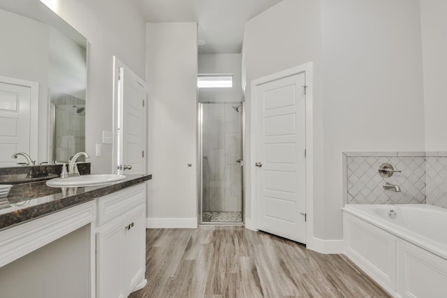 bathroom featuring hardwood / wood-style flooring, vanity, and independent shower and bath