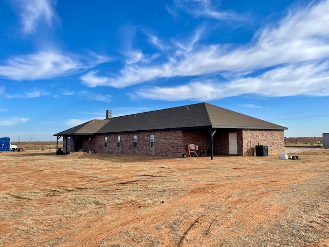 back of house with central AC