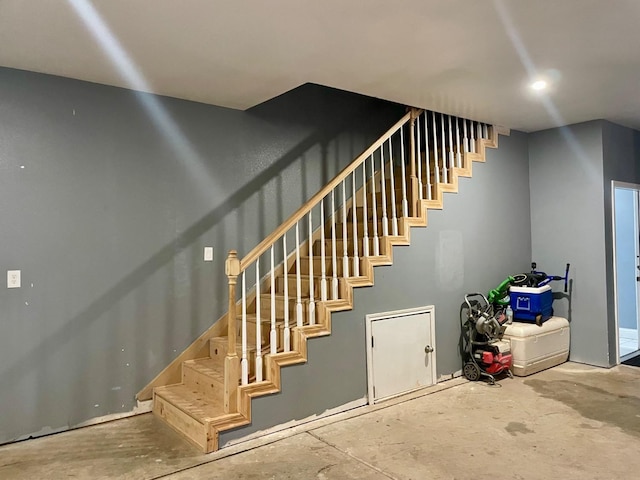 stairs featuring concrete floors