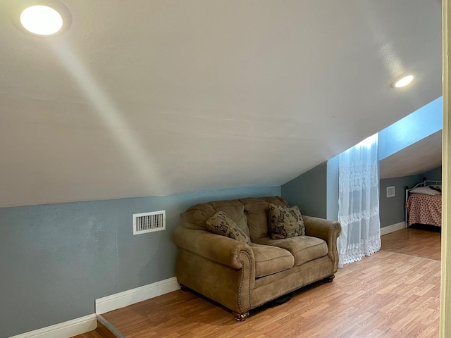 interior space with vaulted ceiling and light wood-type flooring