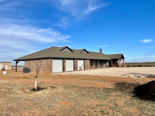 view of property exterior featuring a garage and central air condition unit