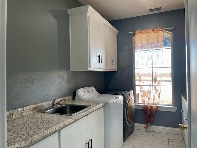 laundry area with cabinets, sink, and washing machine and clothes dryer