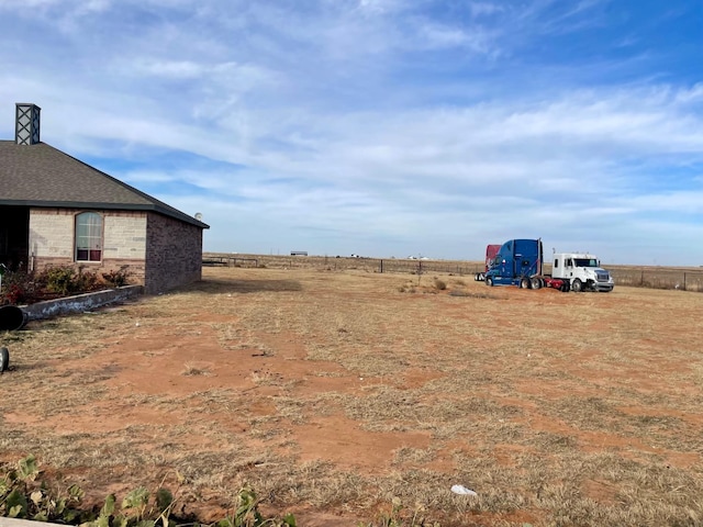 view of yard with a rural view