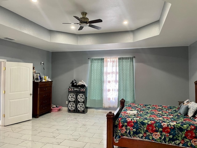 bedroom featuring a tray ceiling and ceiling fan