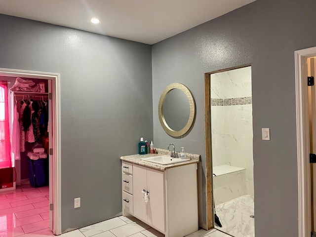 bathroom featuring vanity and tiled shower