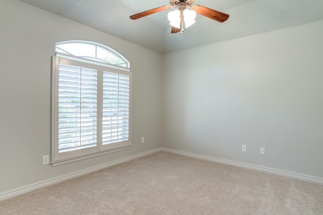 carpeted empty room featuring ceiling fan