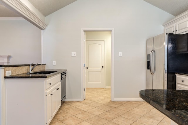 kitchen featuring white cabinetry, sink, light tile patterned floors, and appliances with stainless steel finishes