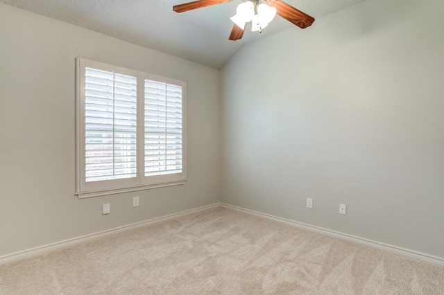 carpeted empty room with lofted ceiling and ceiling fan