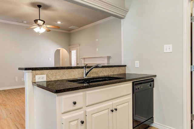 kitchen featuring sink, dishwasher, white cabinetry, tasteful backsplash, and ornamental molding