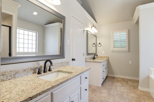 bathroom featuring lofted ceiling, vanity, and a textured ceiling