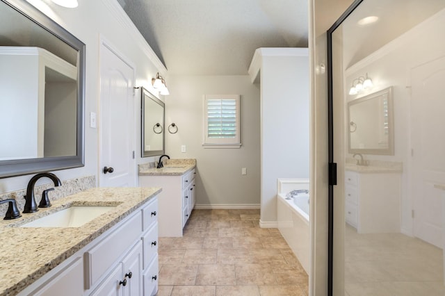 bathroom with vanity, ornamental molding, tiled bath, and a textured ceiling